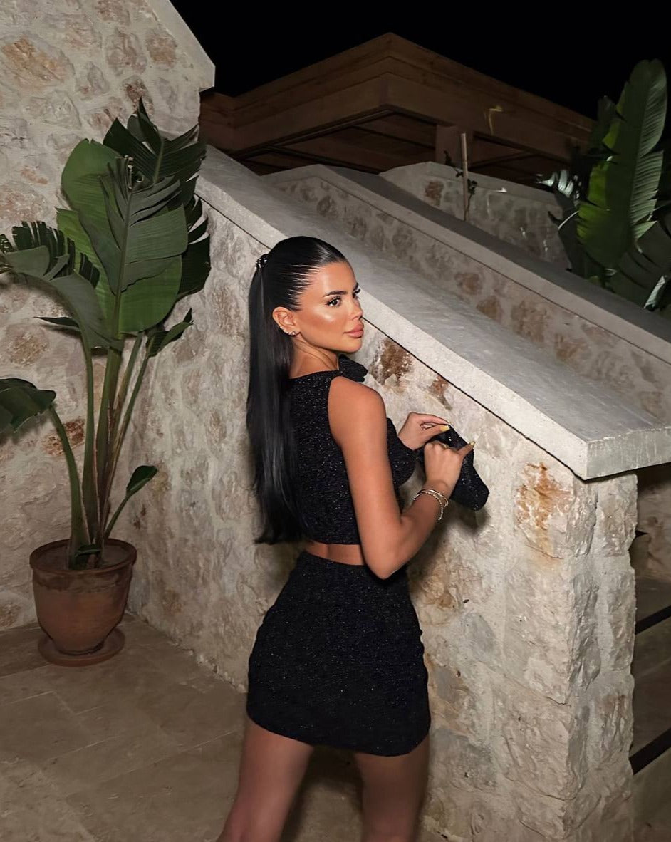 Model posing in the Ibiza Nights Glitter Set at a night out event back view"