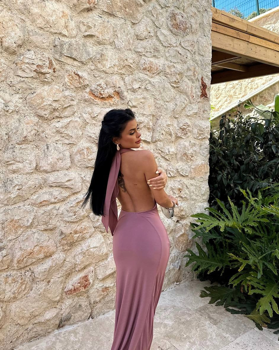 Elegant backless evening gown in dusty rose color modeled outdoors
