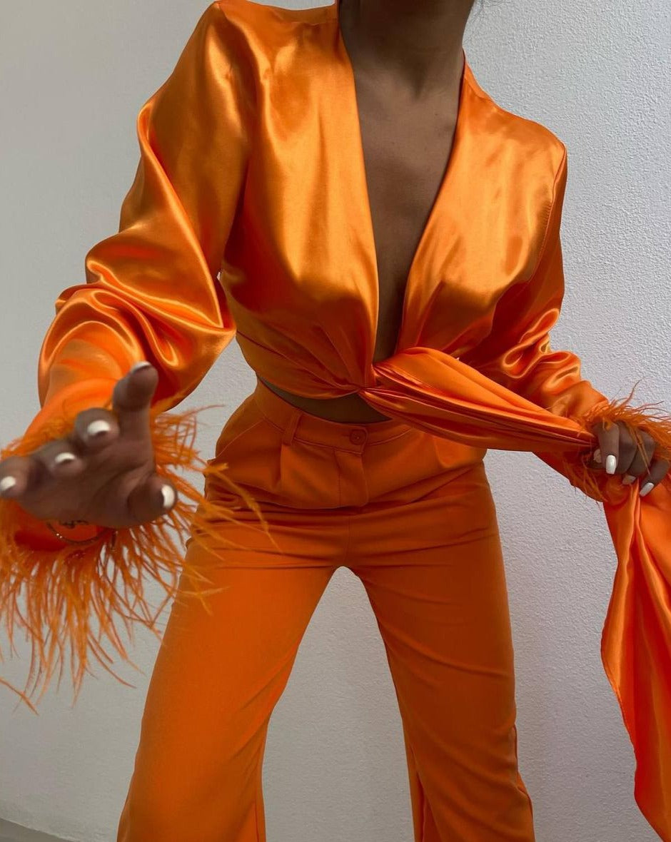 Close-up of feather detail on long sleeves of Ferlayne Orange Crop Top