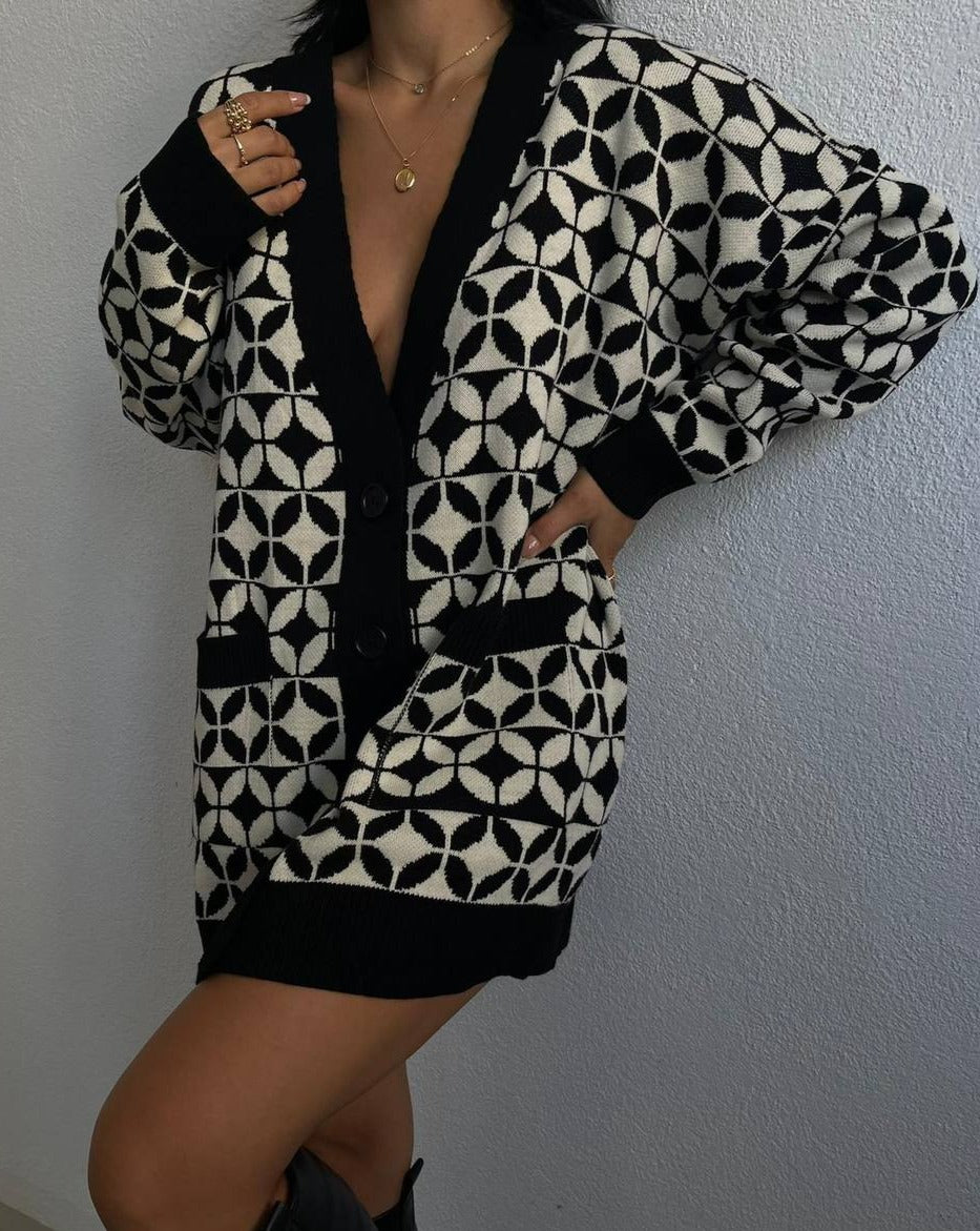 Woman wearing the Kail Jacquard Knit Cardigan in Black & White, styled with jeans for a cozy fall look