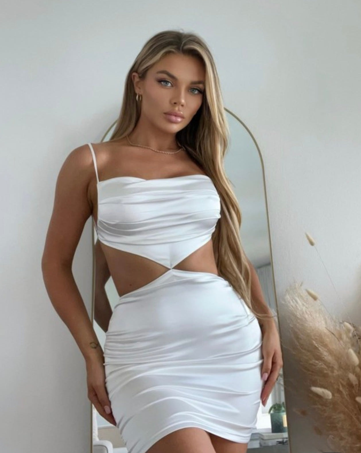 Elegant white satin mini dress with side cutouts and cowl neck detail