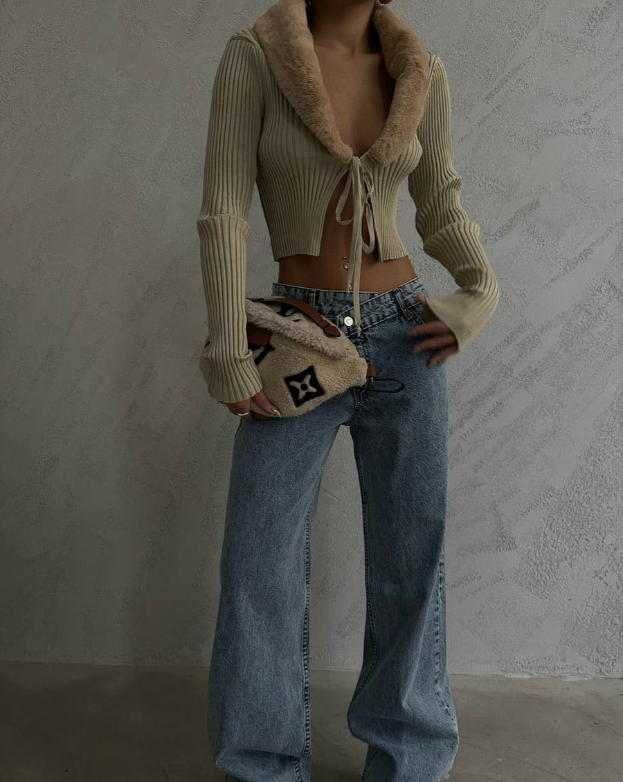 Beige knit ribbed long sleeve cardigan style crop top with front tie adjustable detail and luxurious faux furry neckline. Made of 100% acrylic. Perfect for dressing up or down. Shop now and elevate your wardrobe