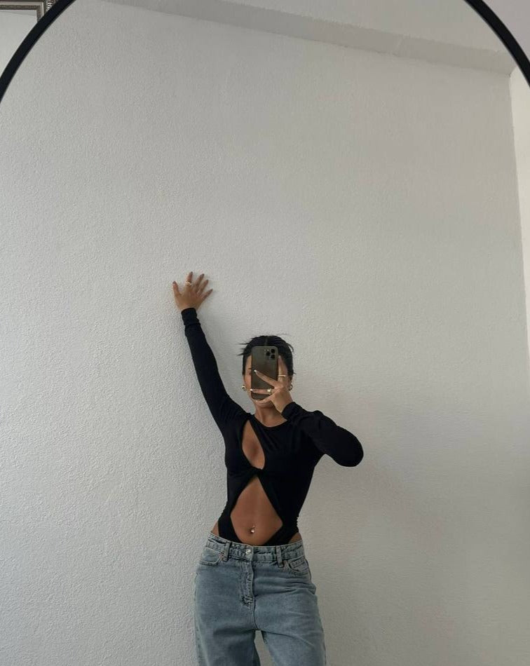 Cyra Cut Out Wrap Front Bodysuit in Black with asymmetric neckline and wrap front tie