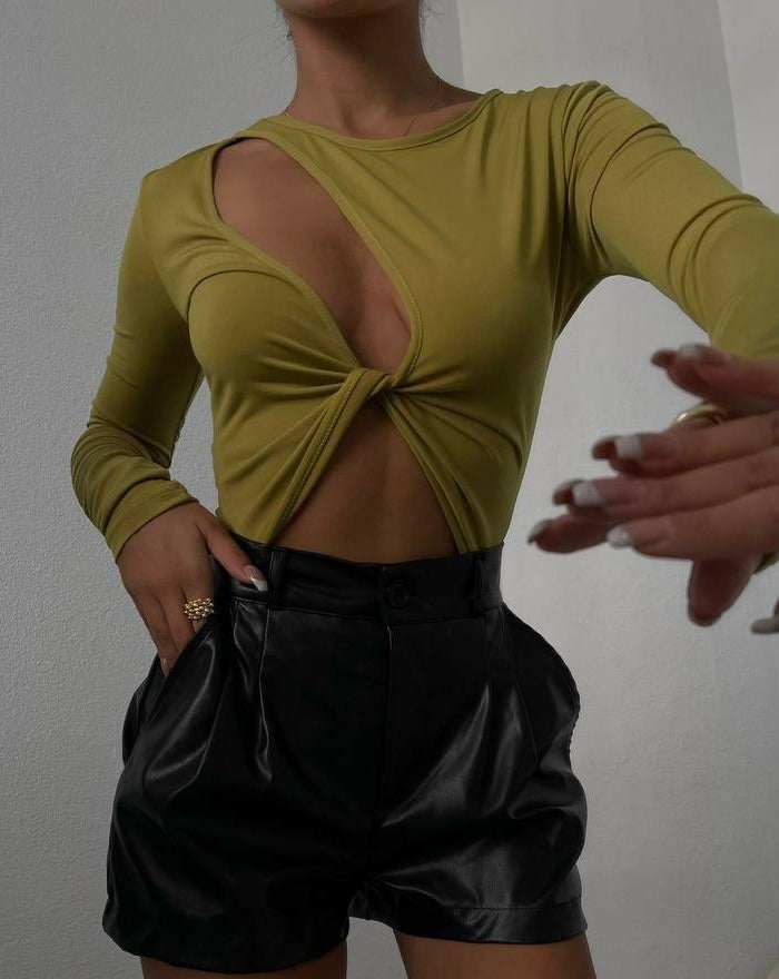 Close-up of the front cut-out detail on the Cyra Olive Wrap Front Bodysuit