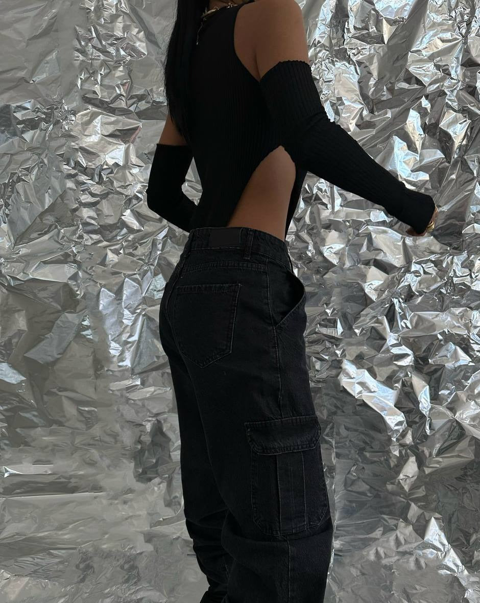 Front side view of black ribbed bodysuit with high cut and long fitted sleeves
