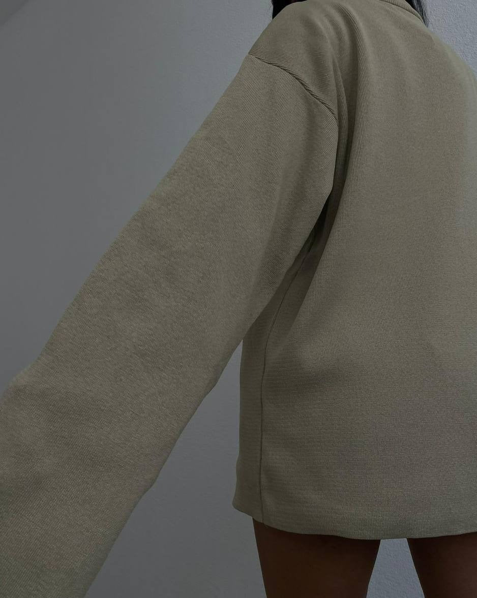 Side view of the Alice Oversized Turtleneck Sweater, showcasing its comfortable fit and flattering silhouette