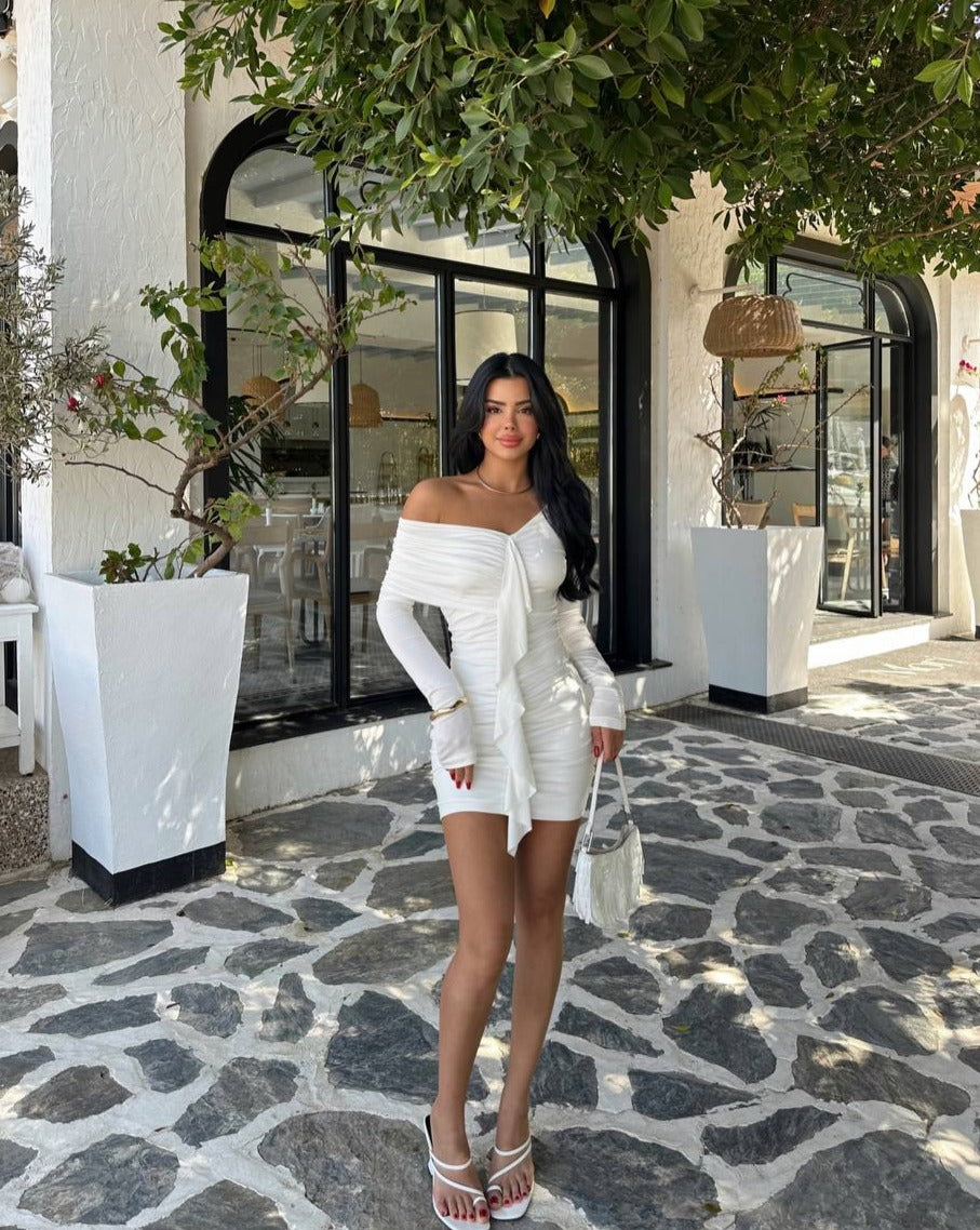 Full view of a white ruffle detail mini dress, showcasing its short length and elegant ruffle details. The dress is made from sandy fabric and is worn by a model who is 160 cm tall and weighs 50 kg."