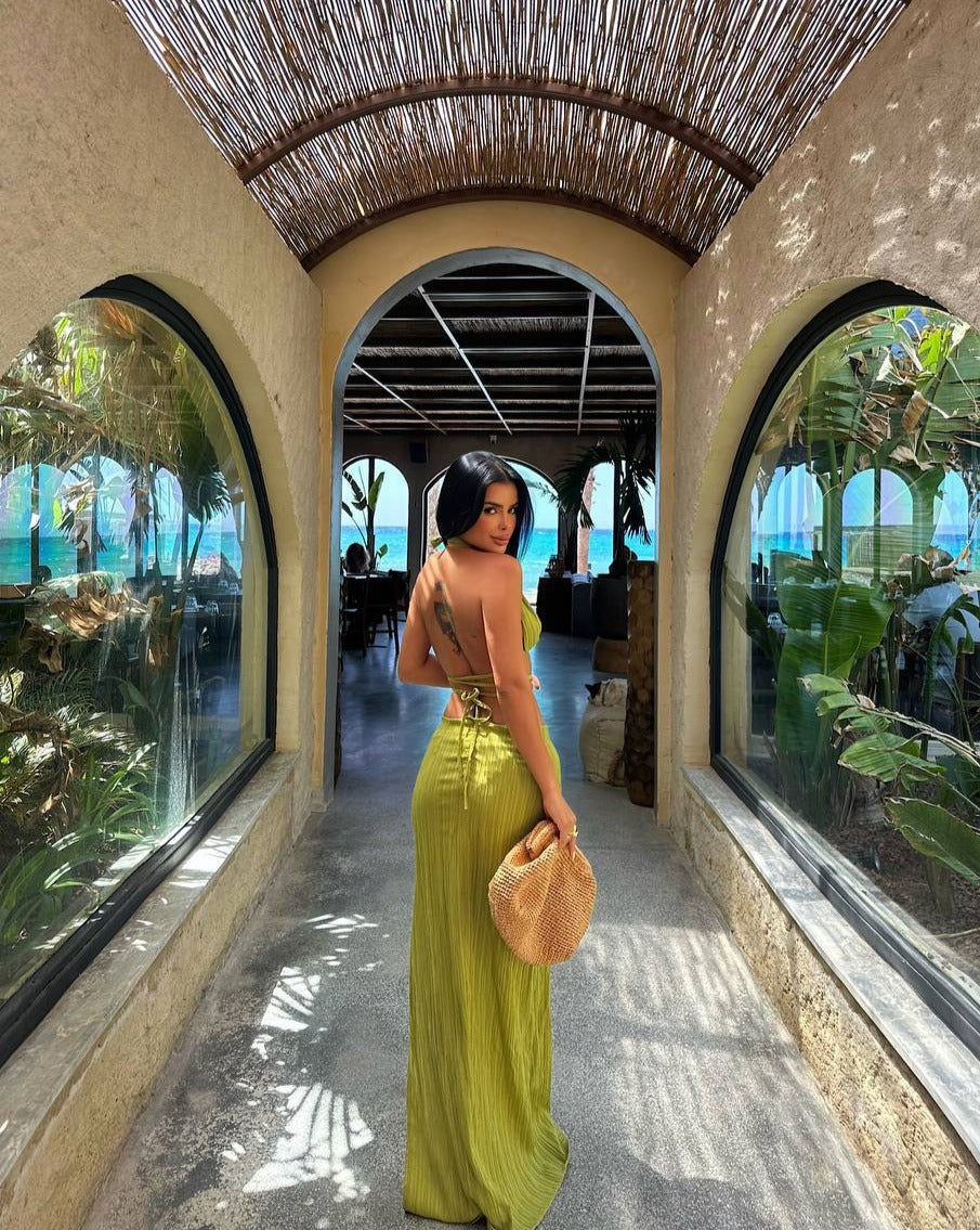 "Side view of the model in the Tropical Chic Set in green, highlighting the fitted silhouette and elegant design."