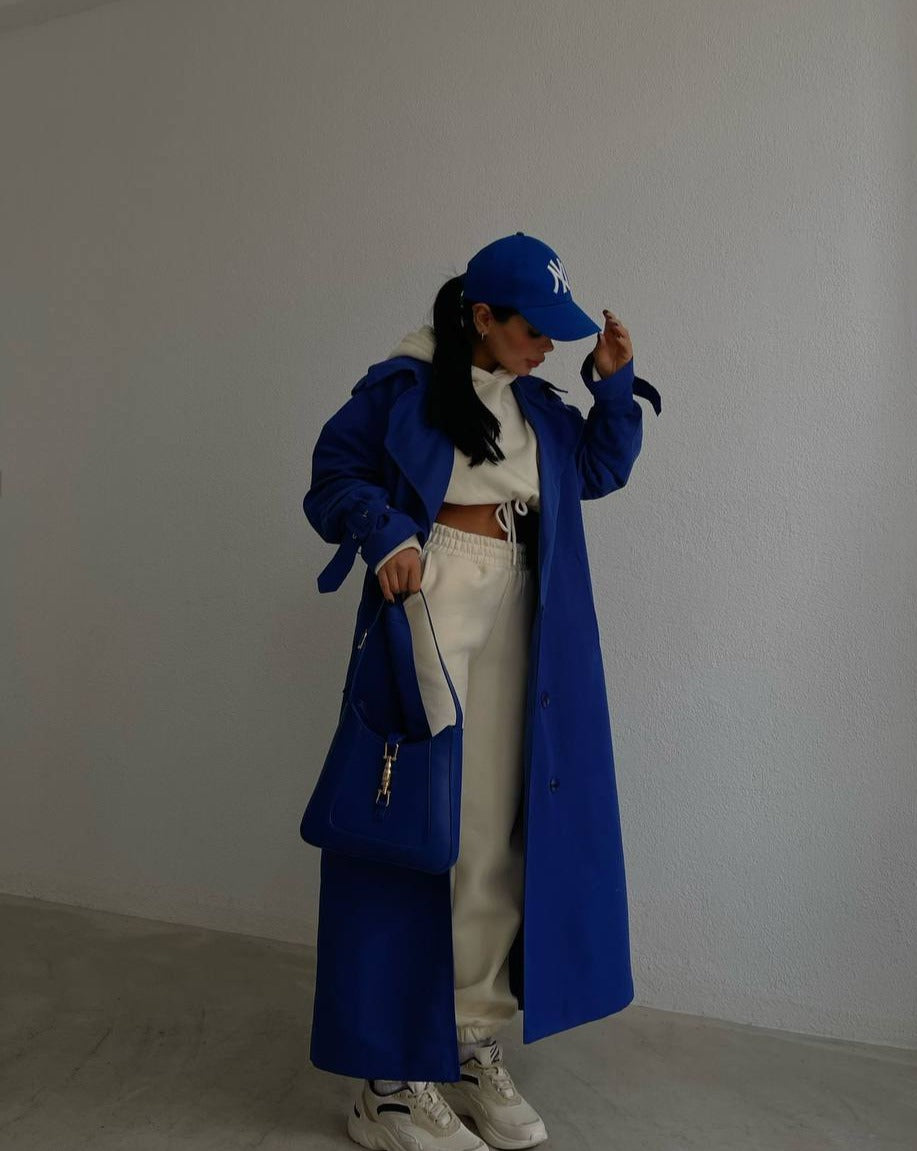 side of the pronounced button detail and waist-defining belt on Mutu's Aisha Blue Maxi Coat, capturing the Neovictoriana essence