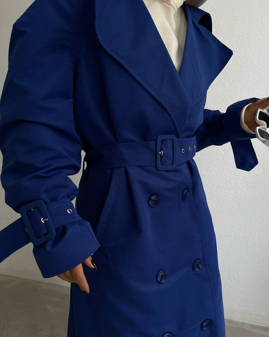 Close-up detail of Mutu's Aisha Blue Trench showcasing the sophisticated lapel collar and belt, resonating with silent fashion aesthetics