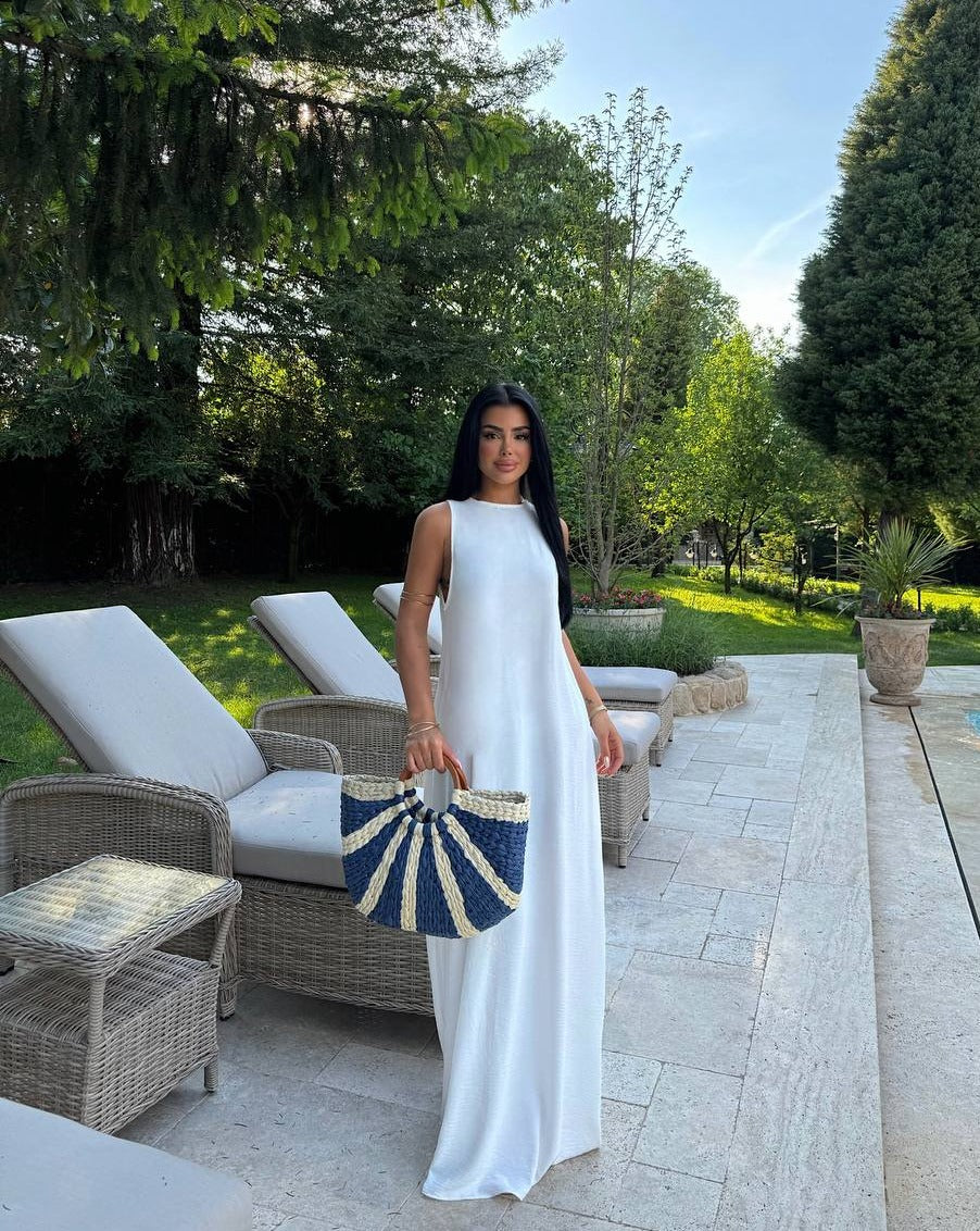 Model posing in the Santorini Breeze Maxi Dress in a garden setting"