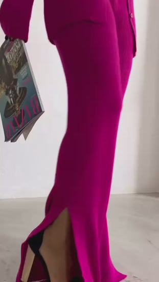 A video showcasing the Eniko Ribbed Knit Blouse & Pant Set, featuring a vibrant pink shade and trendy wide leg hem slit design.