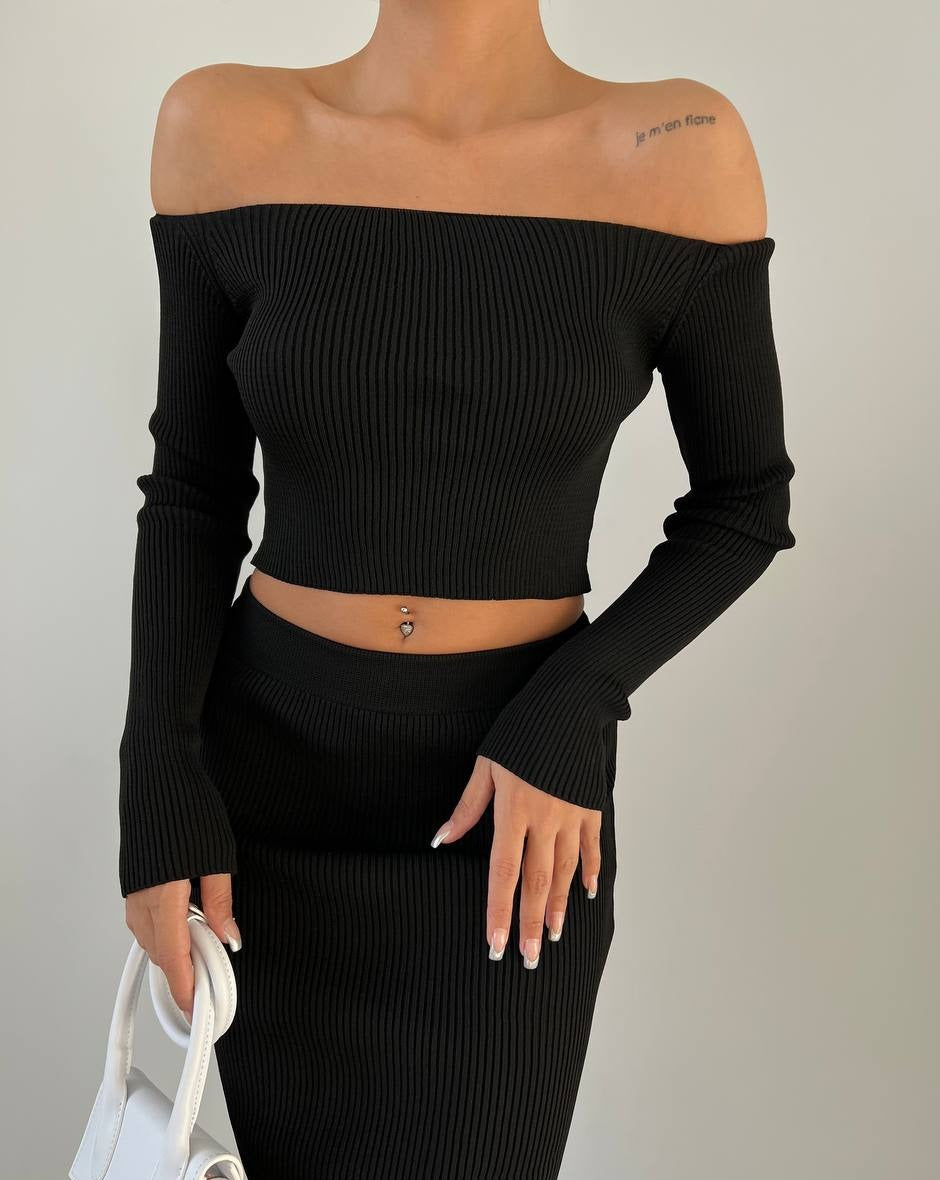 Model wearing PRE-ORDER Ami Long Sleeve Off-Shoulder Top and Midi Skirt Set in black.