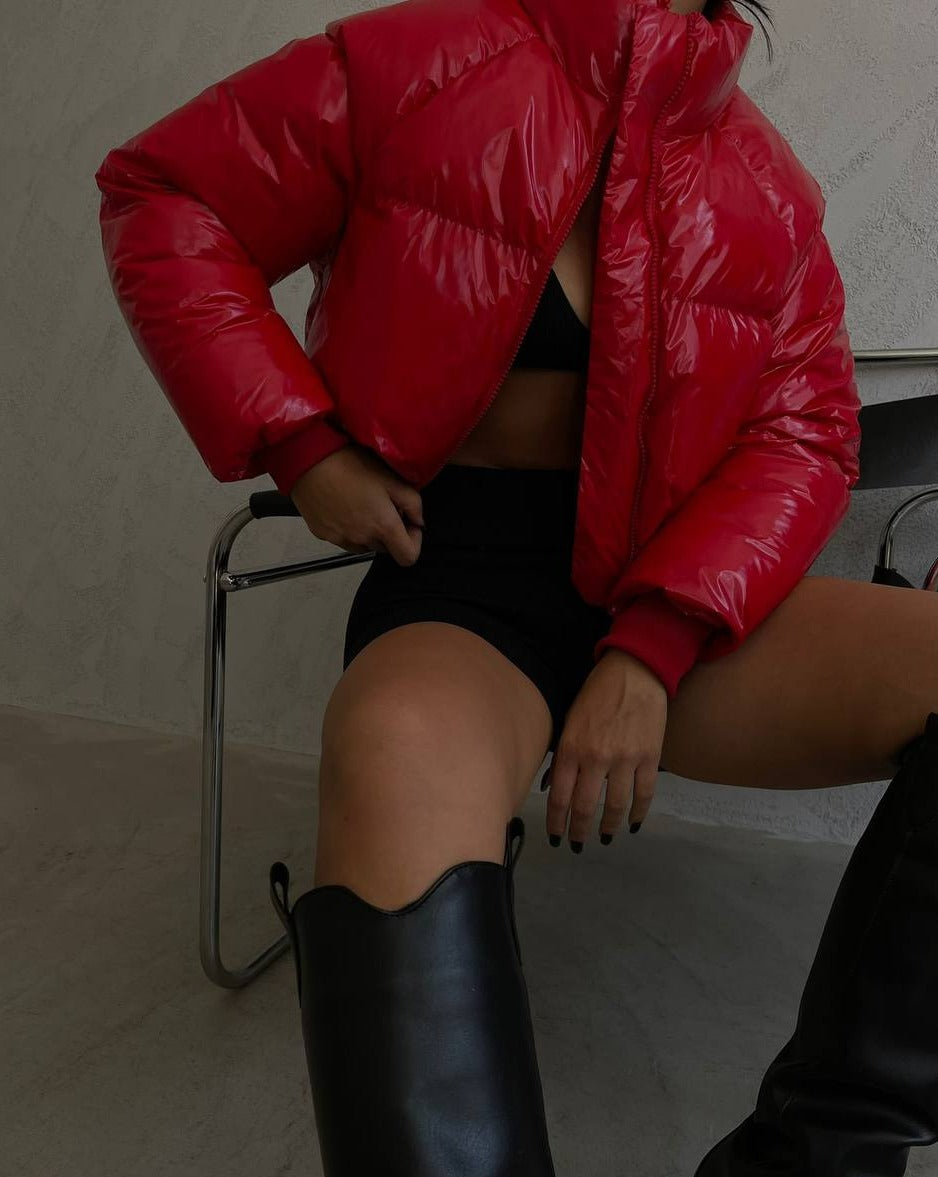 Model wearing red DEVI cropped patent puffer jacket with high collar
