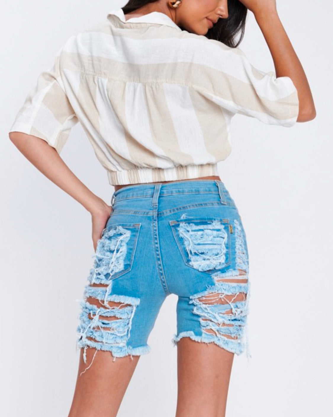 Light stone distressed Bermuda shorts with a bermuda length.