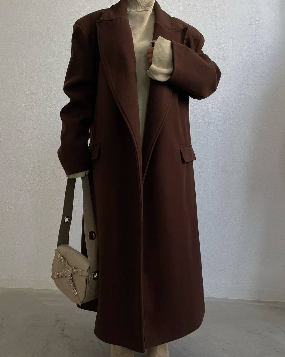 Woman wearing Stassie Long Brown Coat over Beige Top for a chic winter look