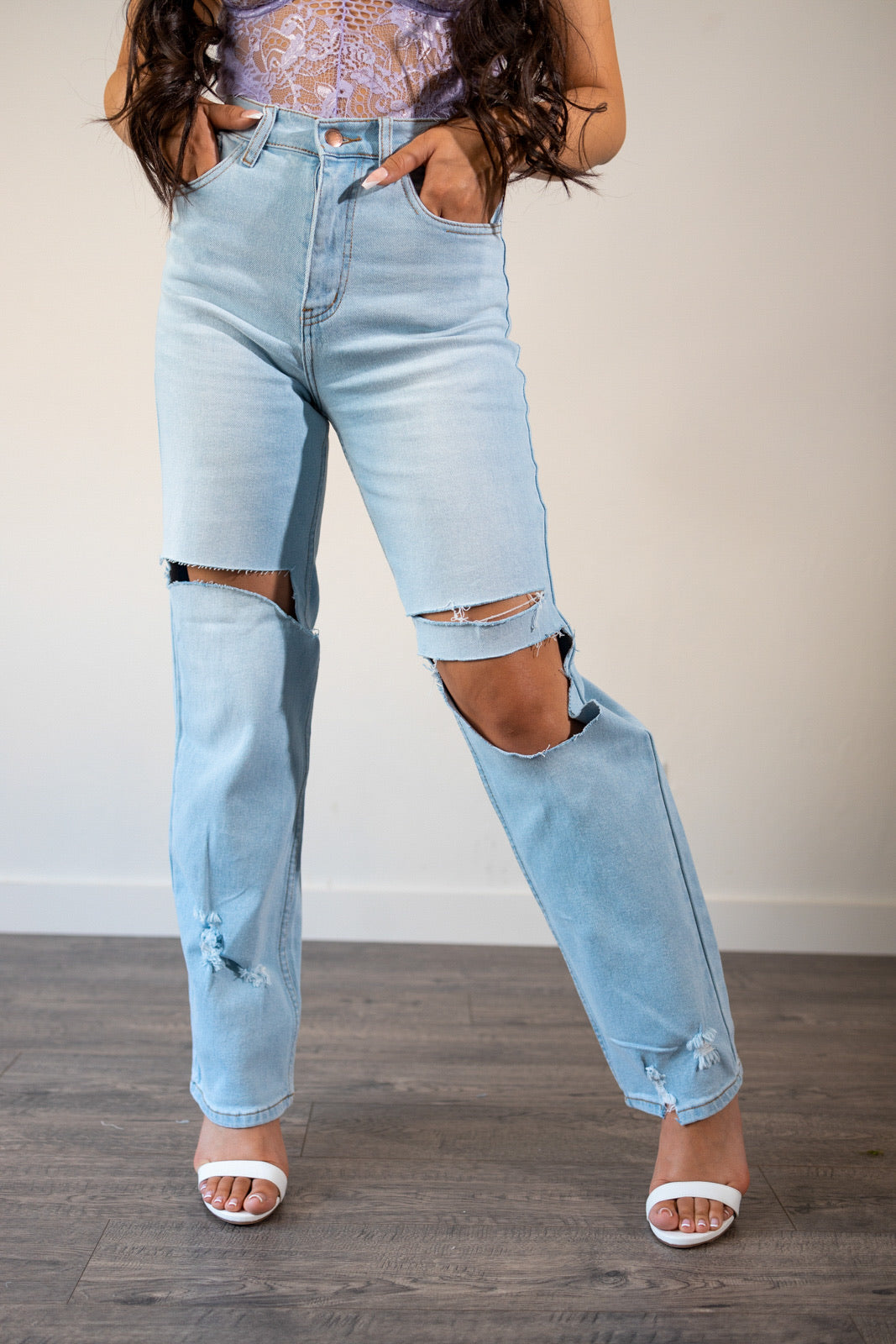 Close-up view of the distressed details and slight slit distress on the hem of the Alyssa Wide Leg Jeans.