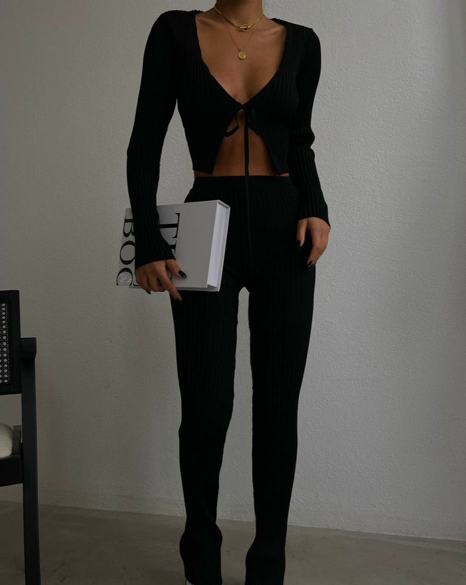 Woman wearing stylish black Aaliyah crop top and pant set