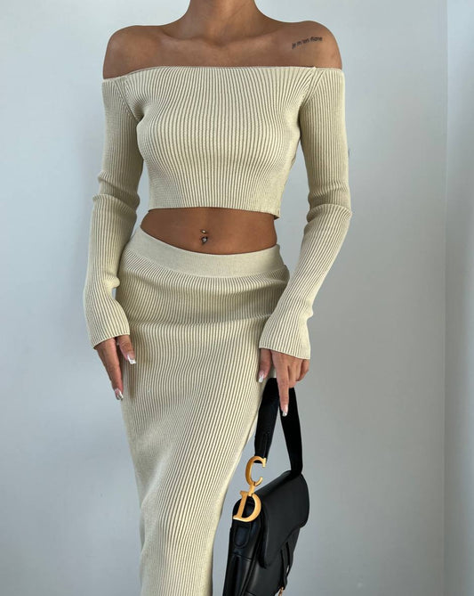 Stylish beige two-piece set featuring off-shoulder crop top and midi skirt