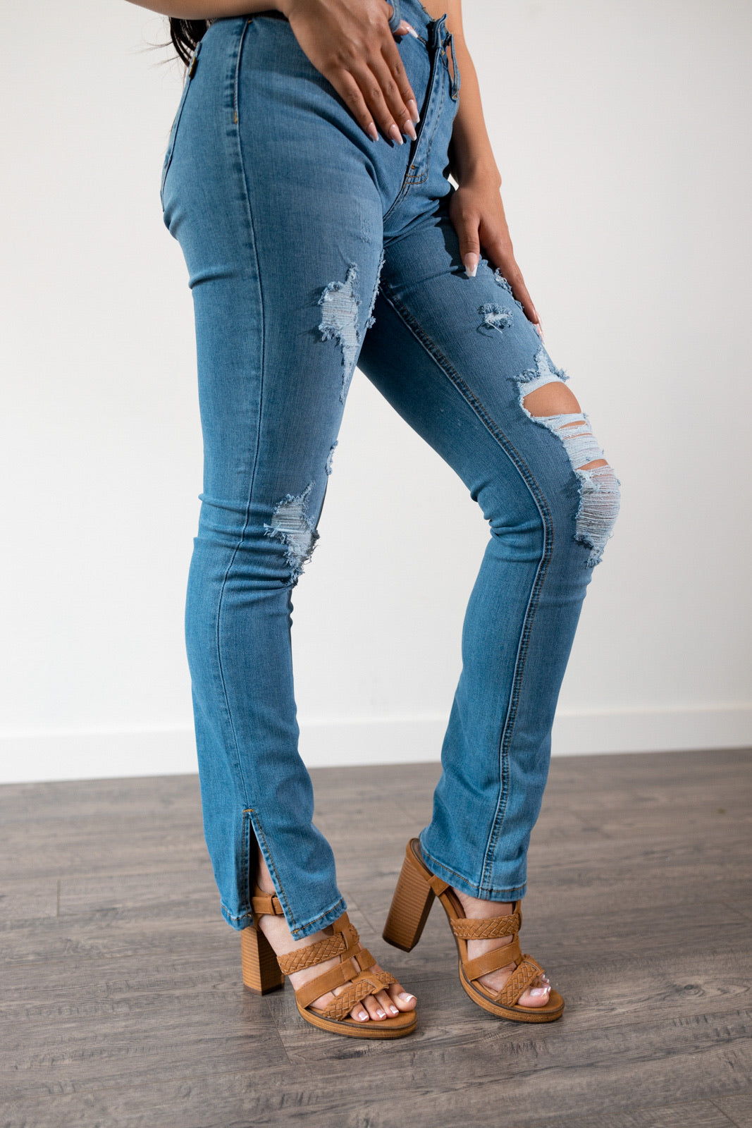Side view of the Malika Distressed High-Rise Bootcut Jeans, highlighting the flattering high-waist fit and bootcut slit design.