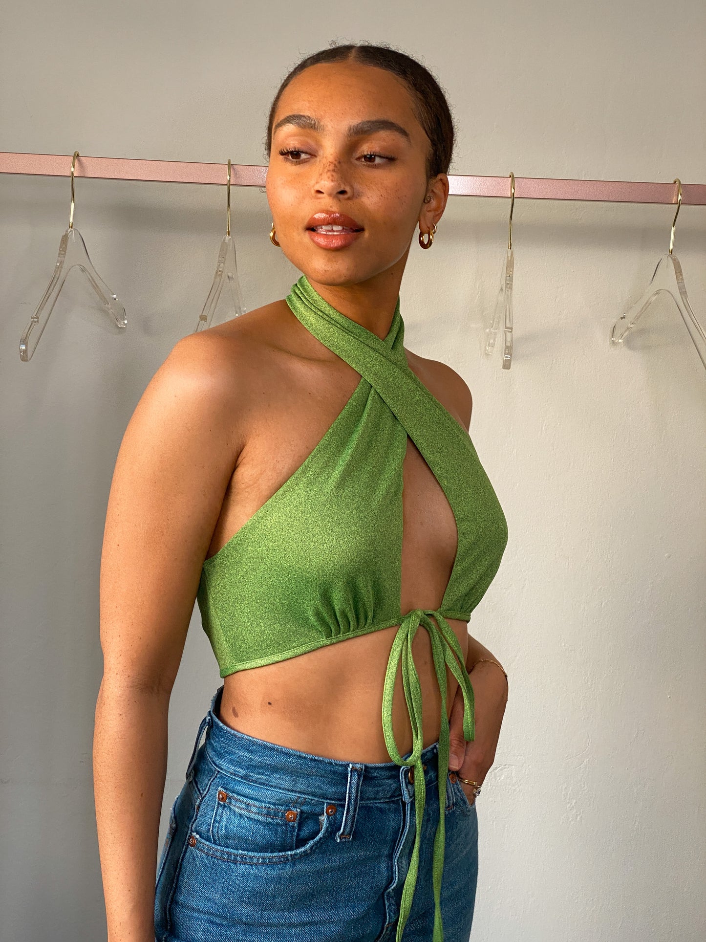 Close-up view of the Suki Green Halter Neck Crop Top, highlighting the micro speckle green fabric and stylish design elements.