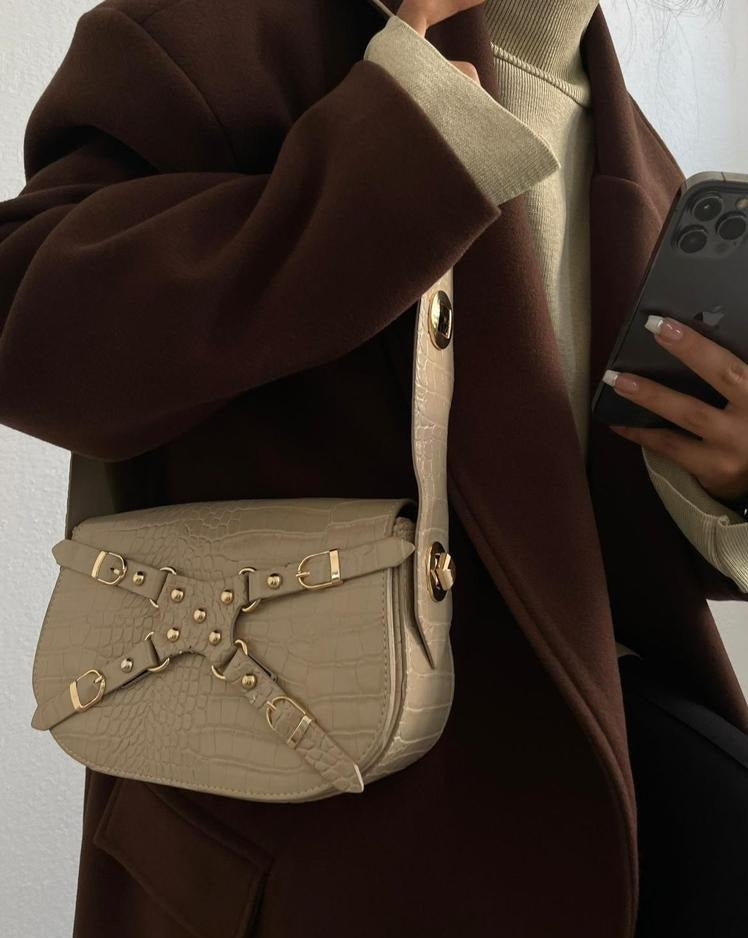 Woman wearing the Lena Beige Shoulder Bag, paired with a fashionable outfit for a chic look